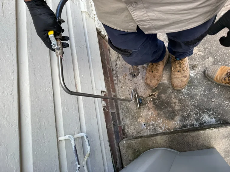 Treatment equipment positioned at a building edge during post-construction work.