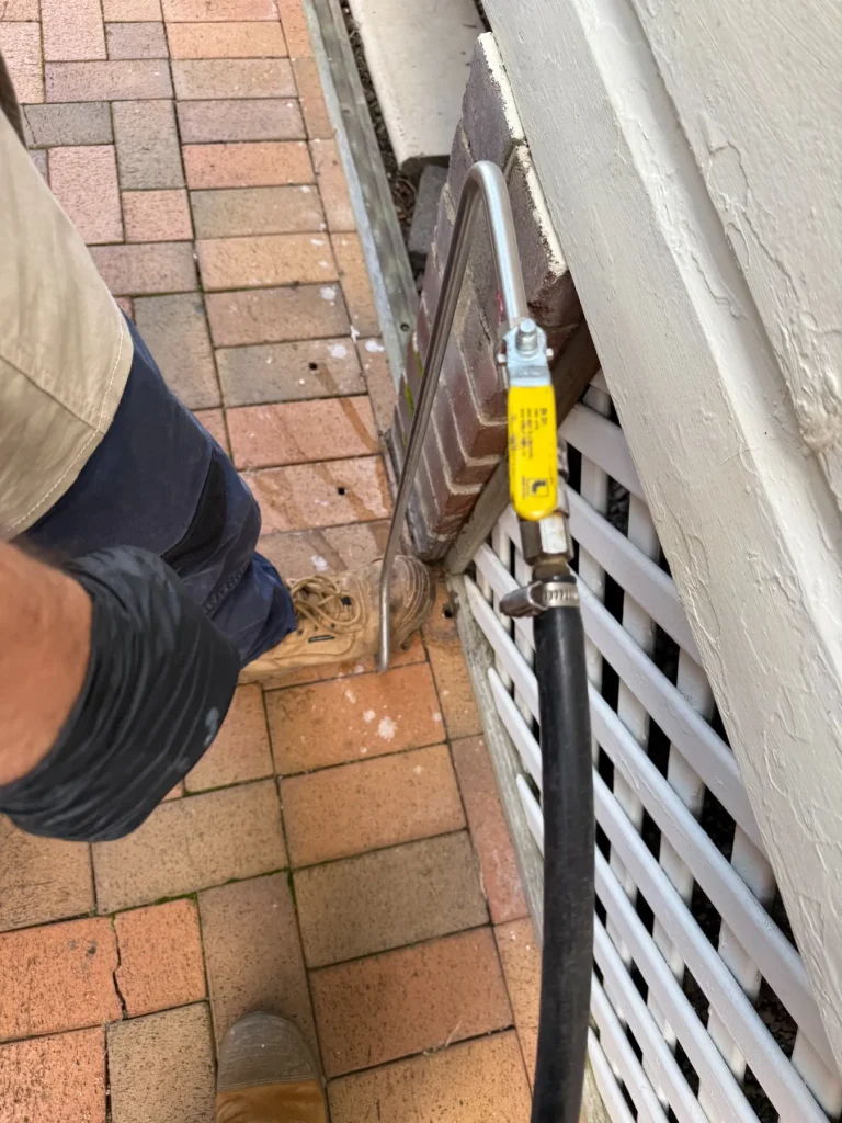 Targeted treatment work being carried out along an exterior masonry perimeter.