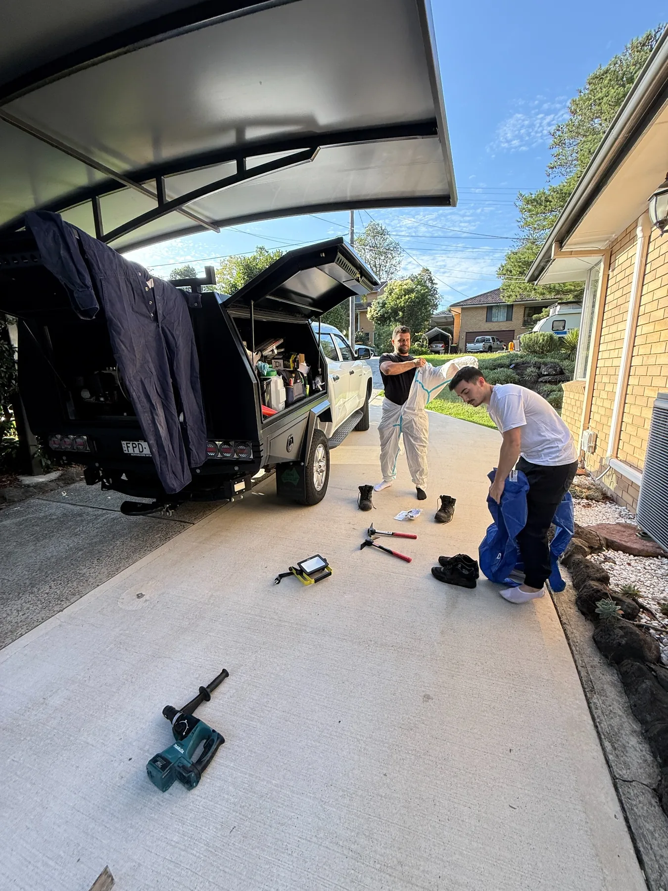 Goliath Pest Solutions technicians preparing for termite treatment at a Sydney property