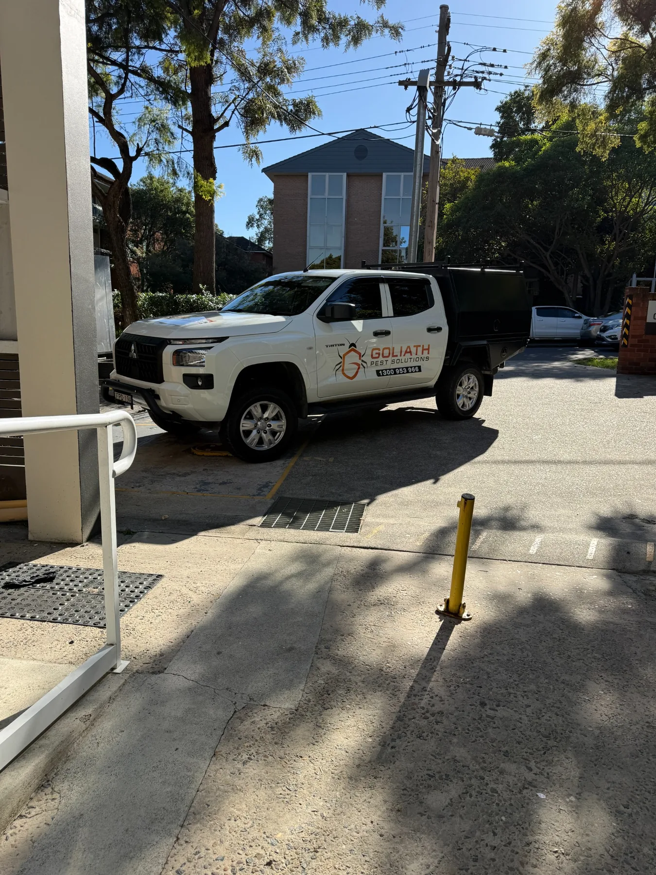 Branded Goliath Pest Solutions ute at a Sydney property