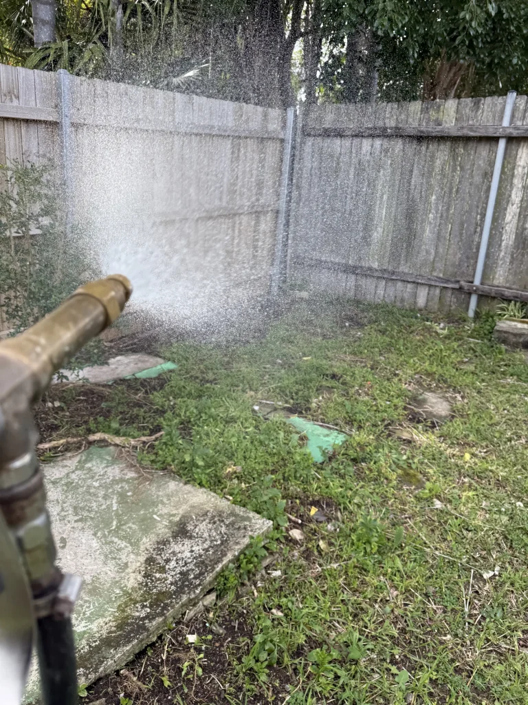 External liquid treatment being applied along a property perimeter.