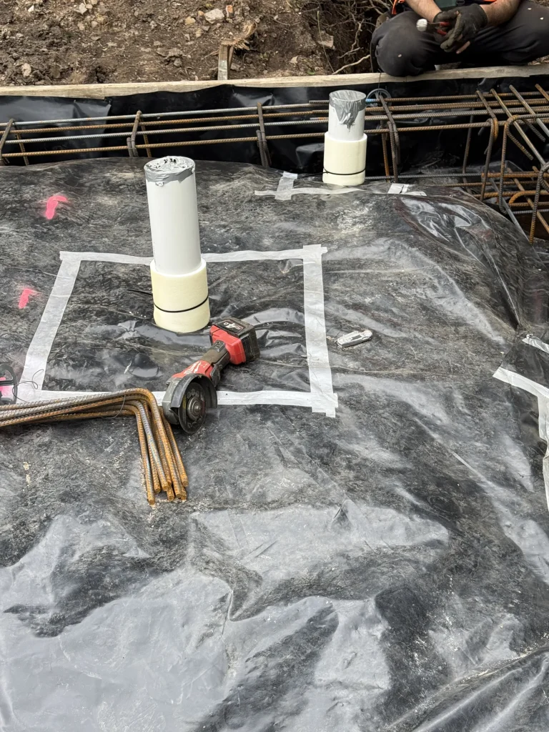 Pre-construction detailing around service penetrations before the slab is completed.