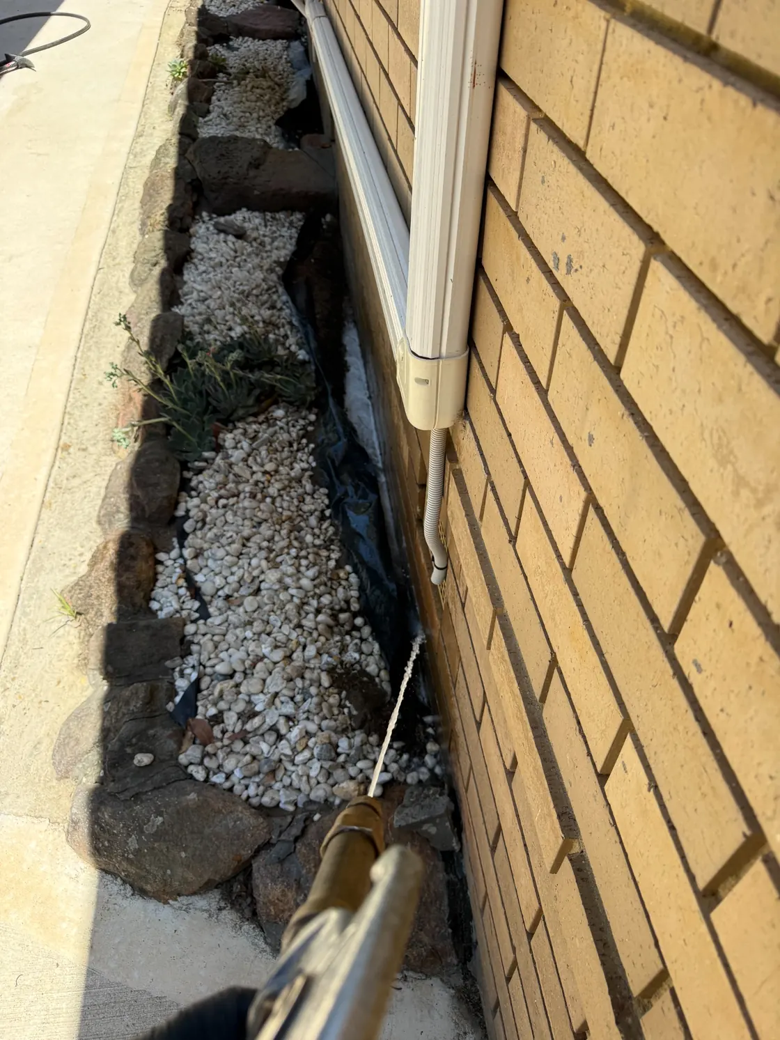 External soil treatment near downpipe and gravel bed at Epping residence