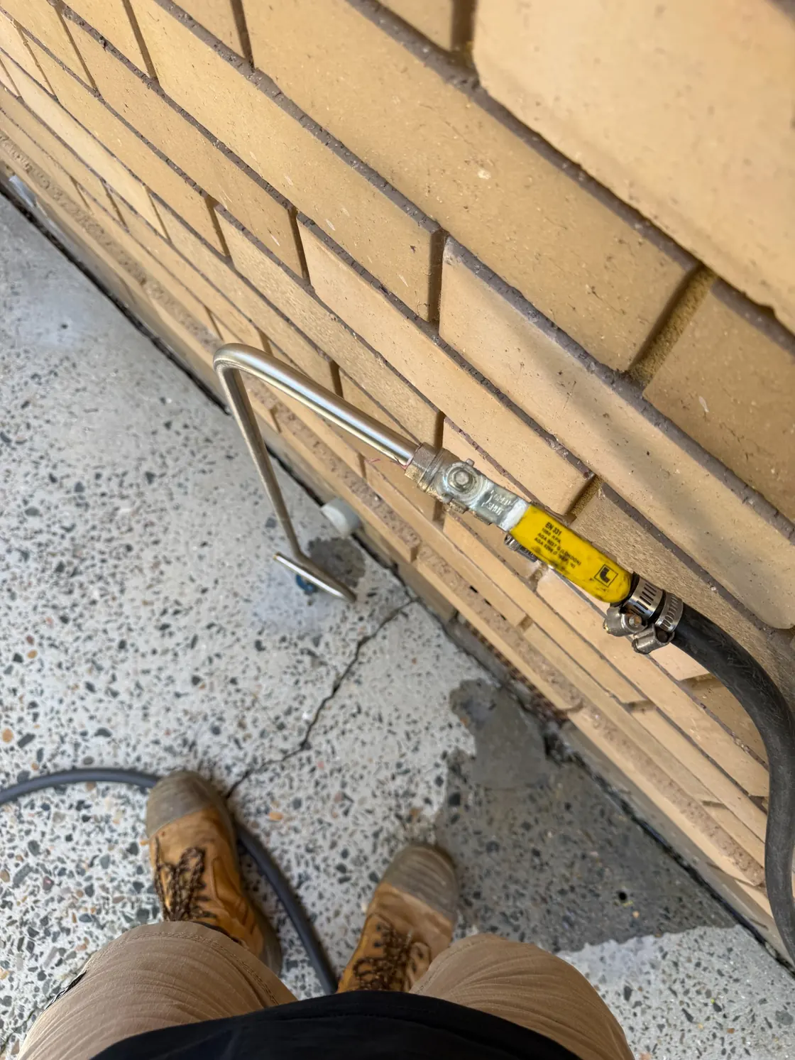 Drill and inject termite treatment equipment beside Epping brick house