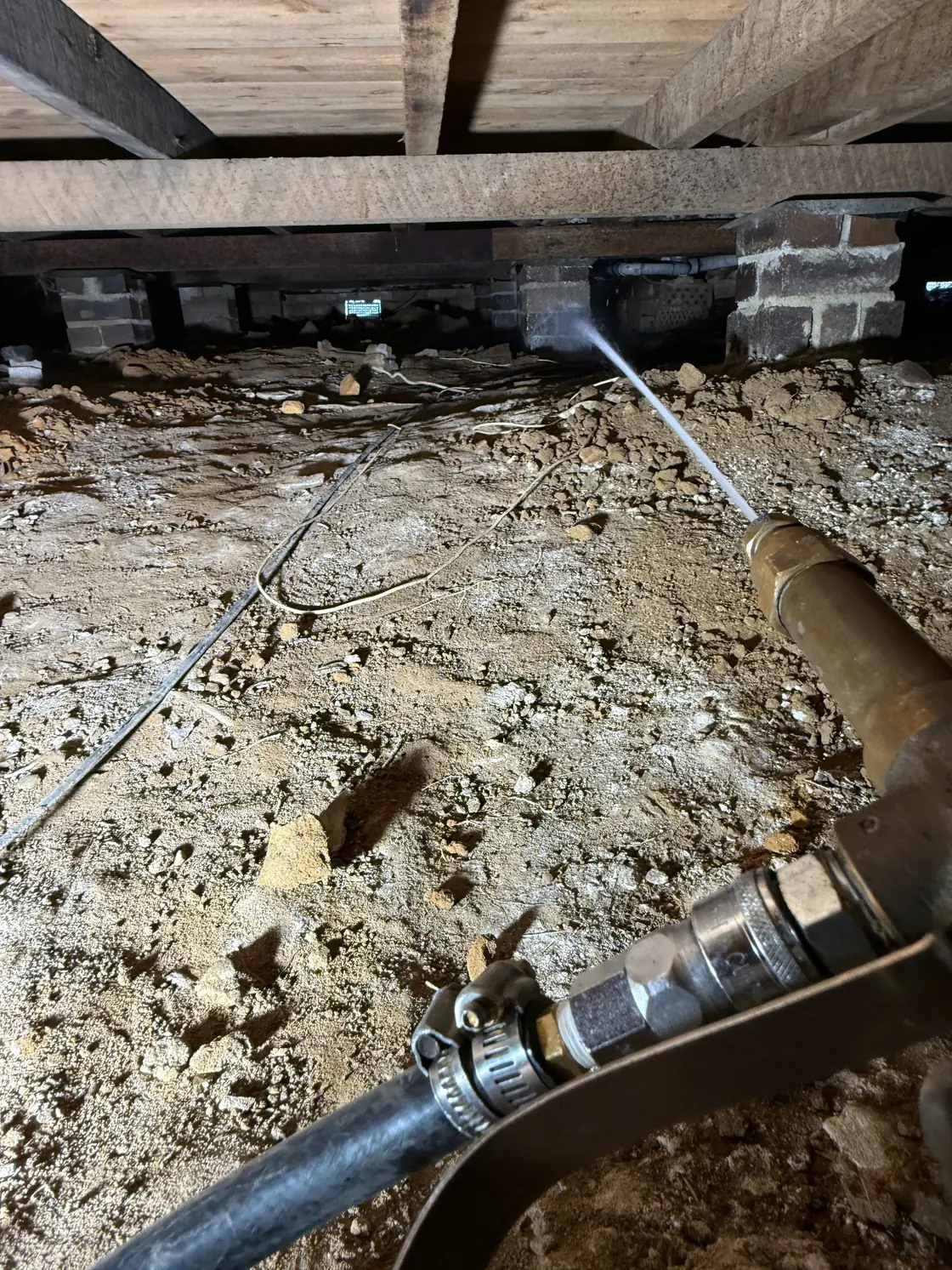 Subfloor soil treatment across ground near brick foundation piers under Epping home