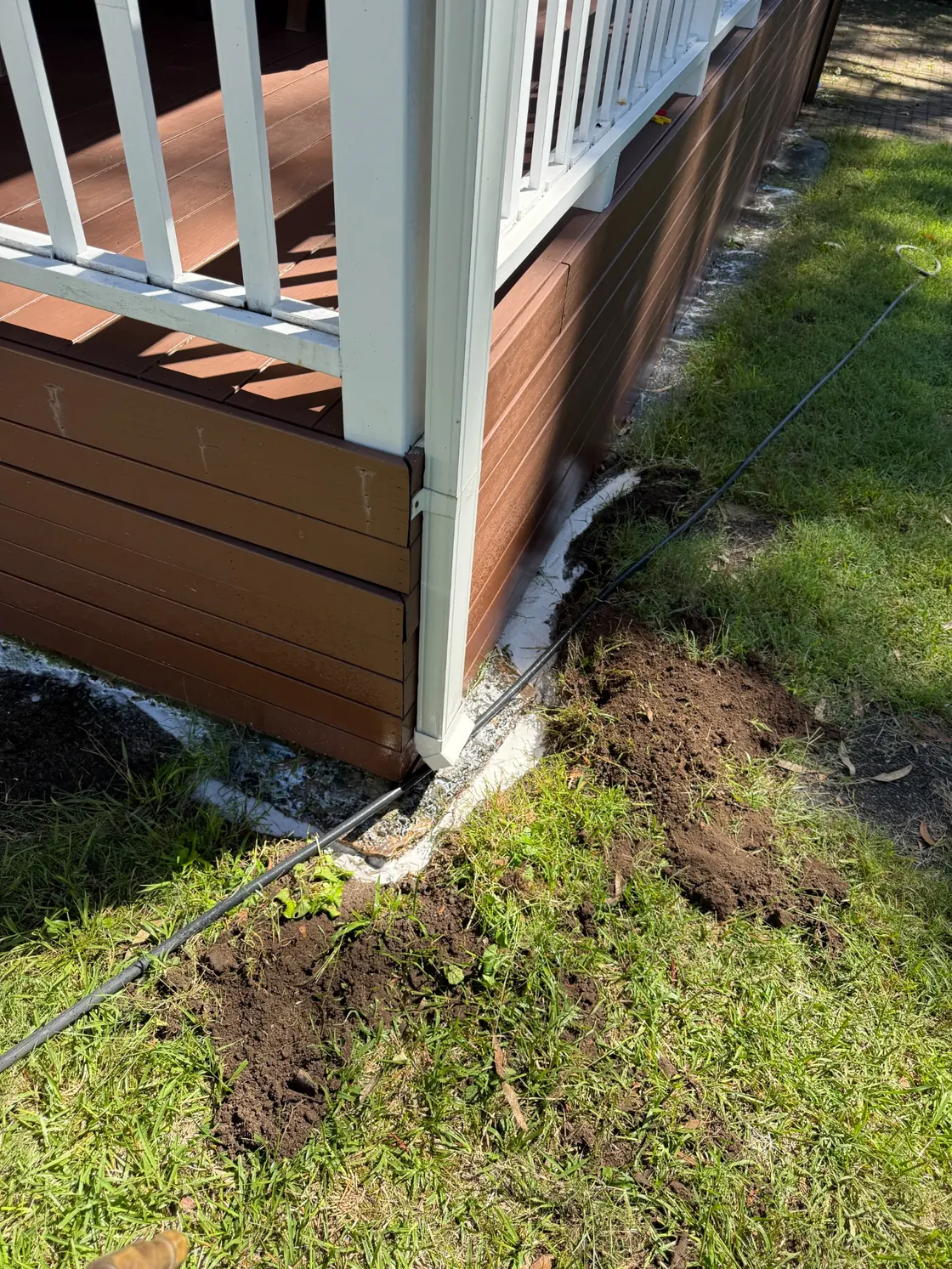 Perimeter trench prepared beside raised timber deck at Epping residence