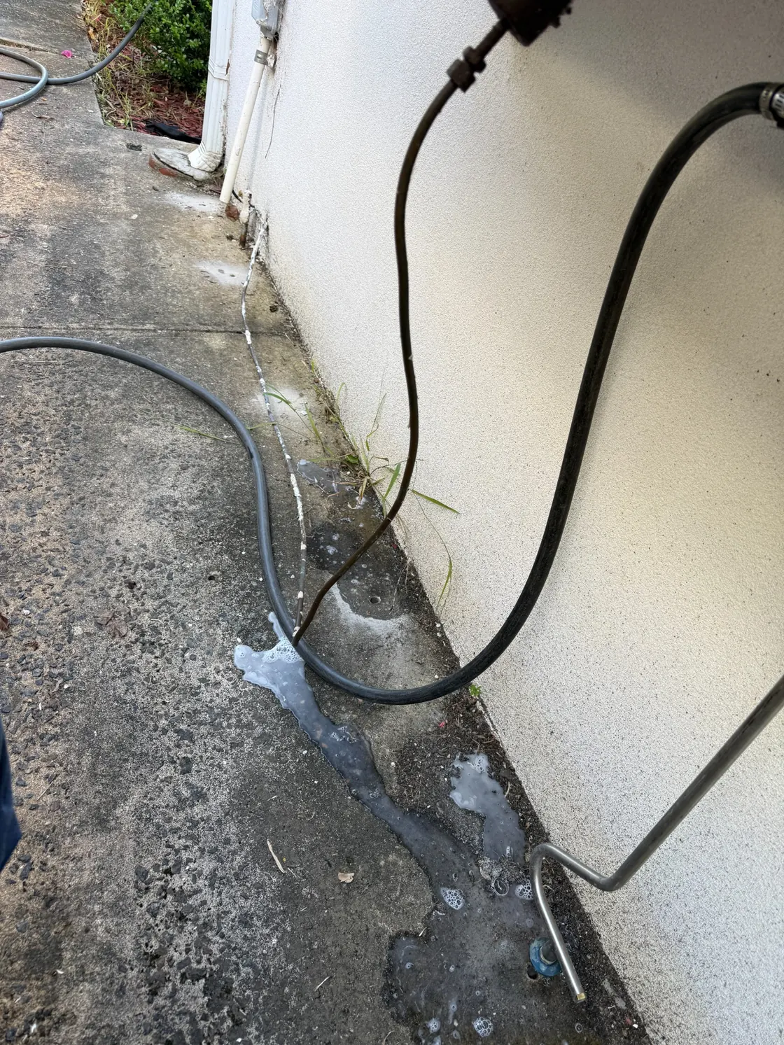 Termite treatment injection equipment positioned beside drilled concrete at Epping home