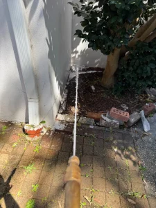 Termidor HE soil treatment being applied beside an Epping home near paving and garden beds
