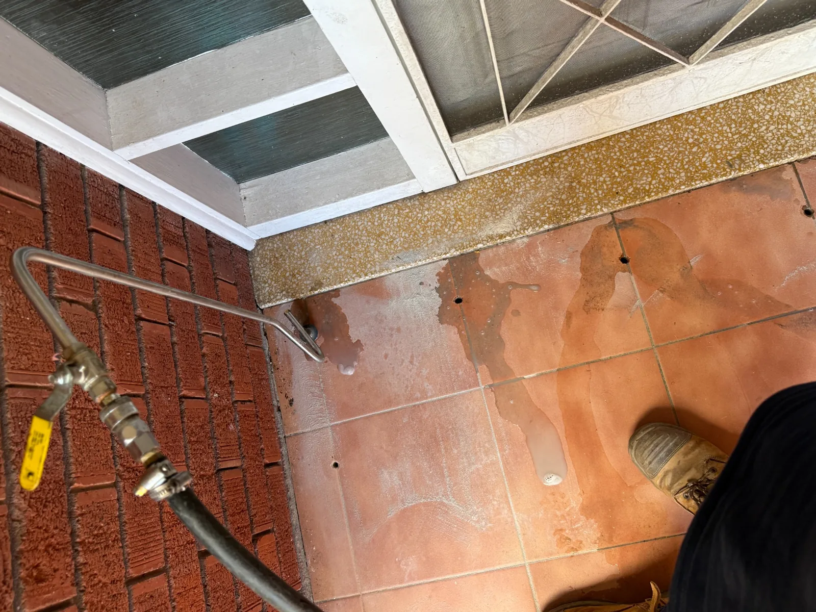 Drilled access points in a tiled entrance during Termidor HE treatment in Killara
