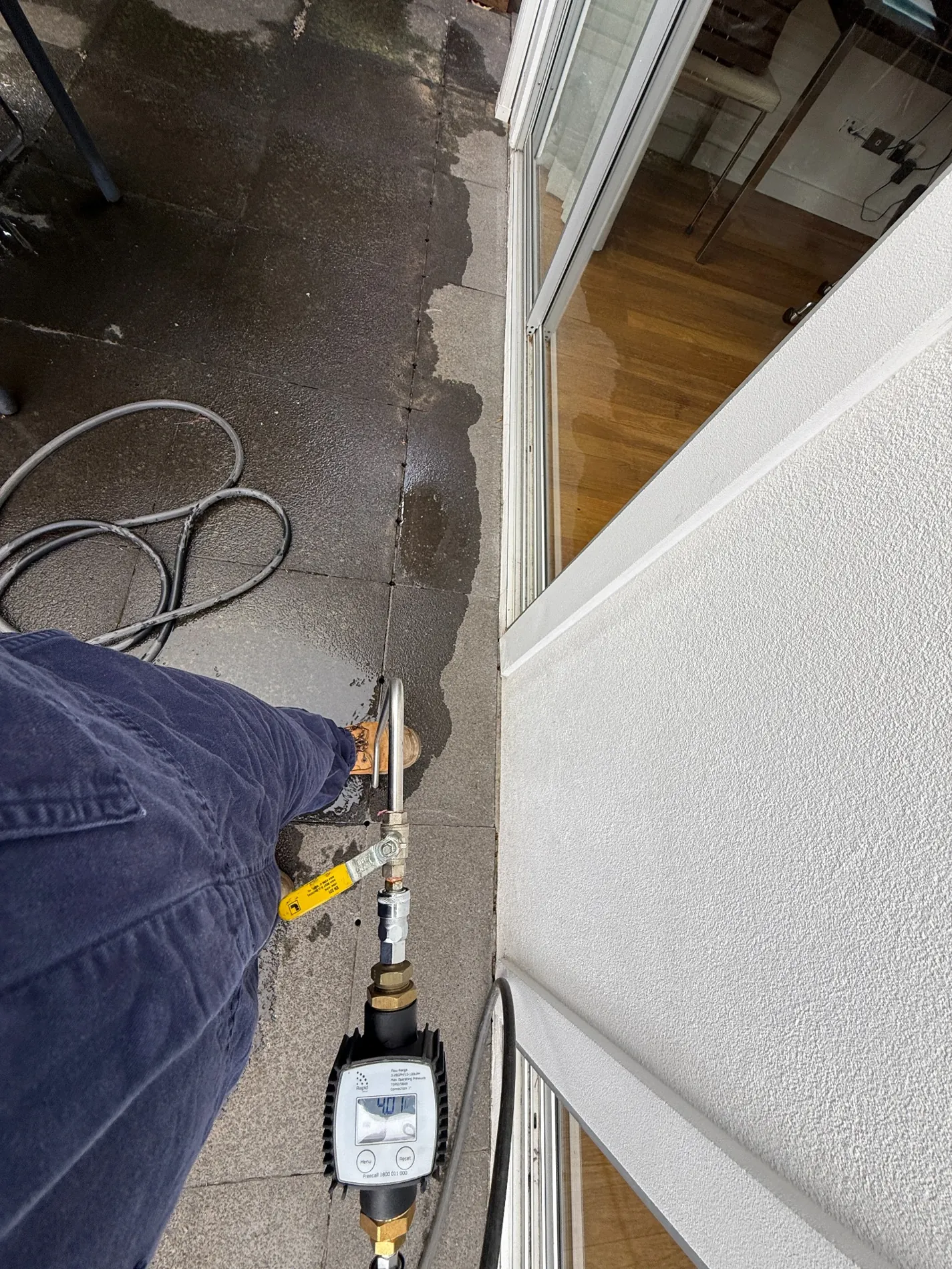 Termidor HE injection equipment and drilled treatment access points in hard paving at Maroubra