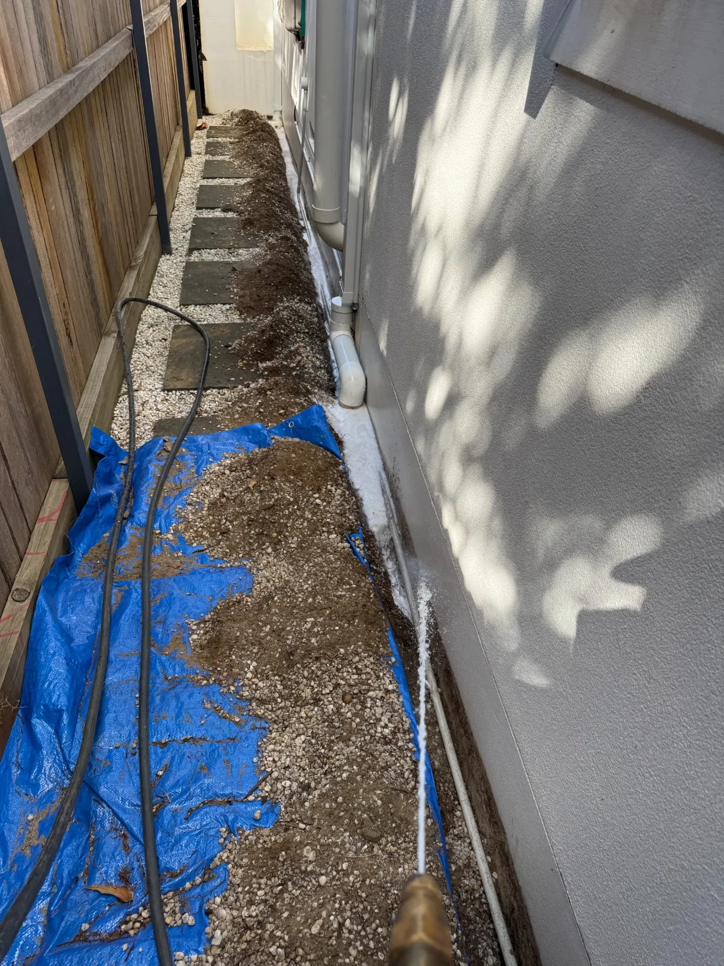 Trenching and liquid soil treatment along narrow side passage of an existing Maroubra house