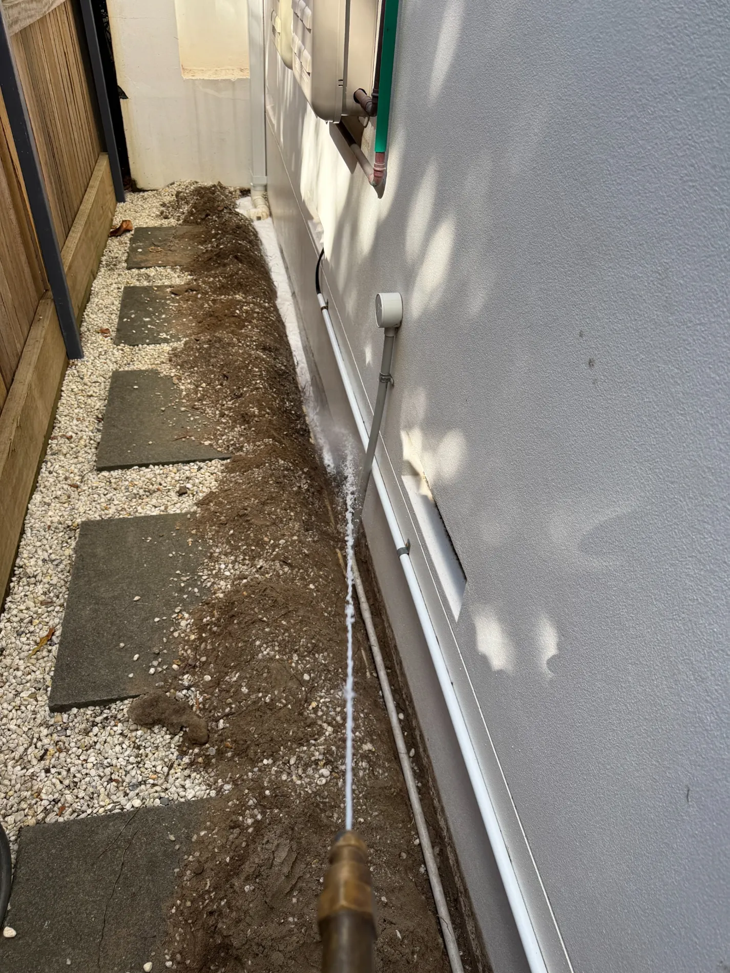 Application lance directed at perimeter trench next to an existing residential wall in Maroubra