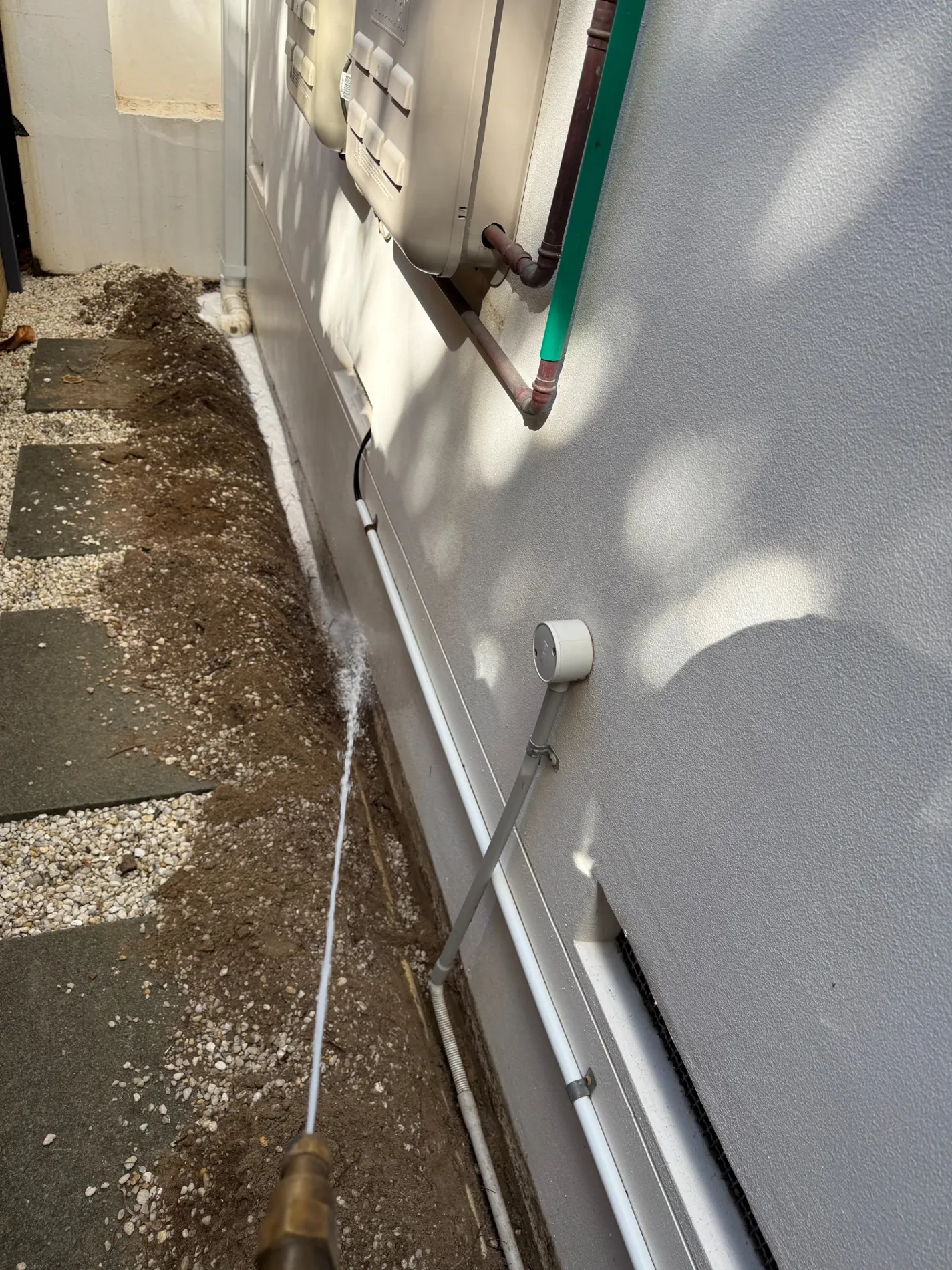 Perimeter soil treatment work beside plumbing and external wall of Maroubra home